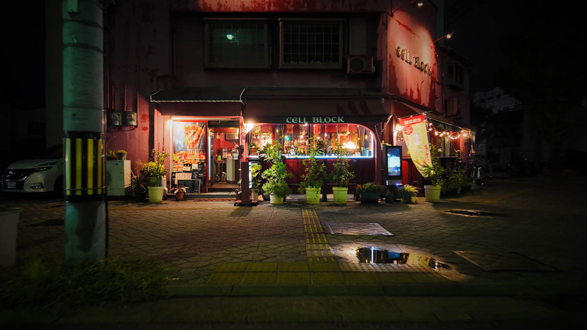 A bold red dining bar on Yanagi-dori, standing out against the dark street