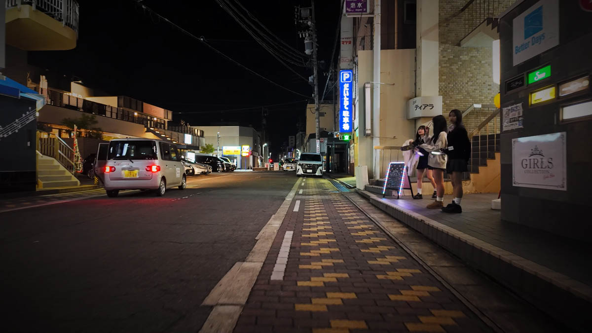 Main street at night The main street at night, women in schoolgirl-style outfits standing outside