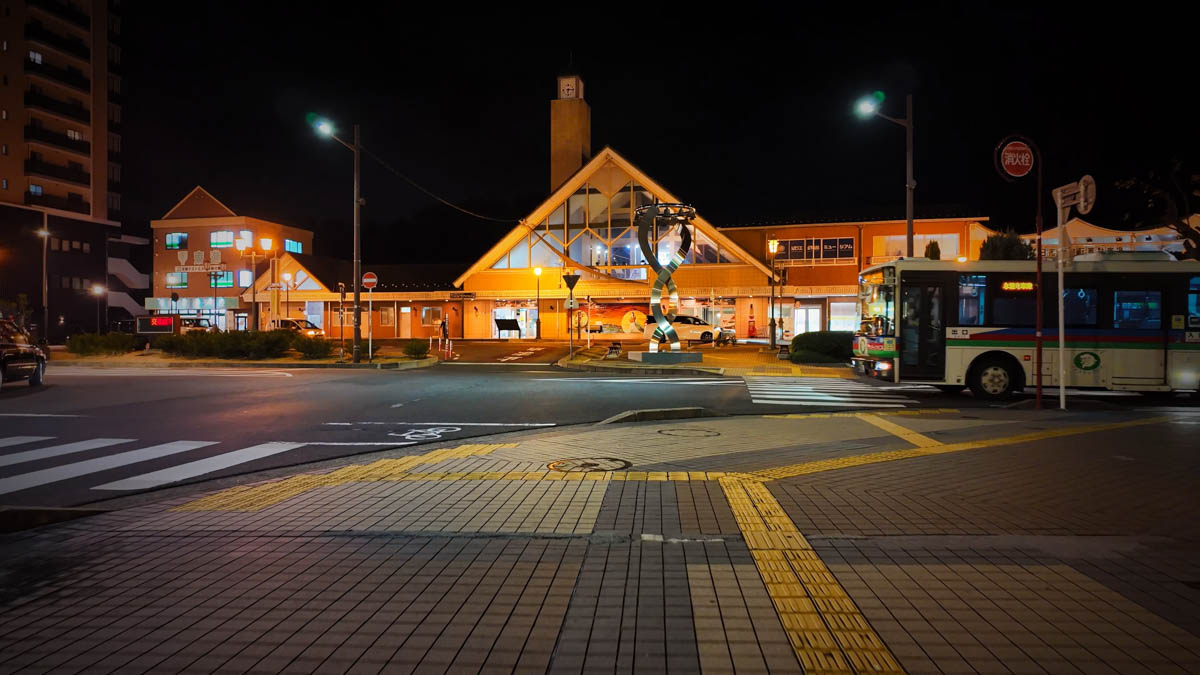 The exterior of Yokaichi Station at night, its design quietly charming