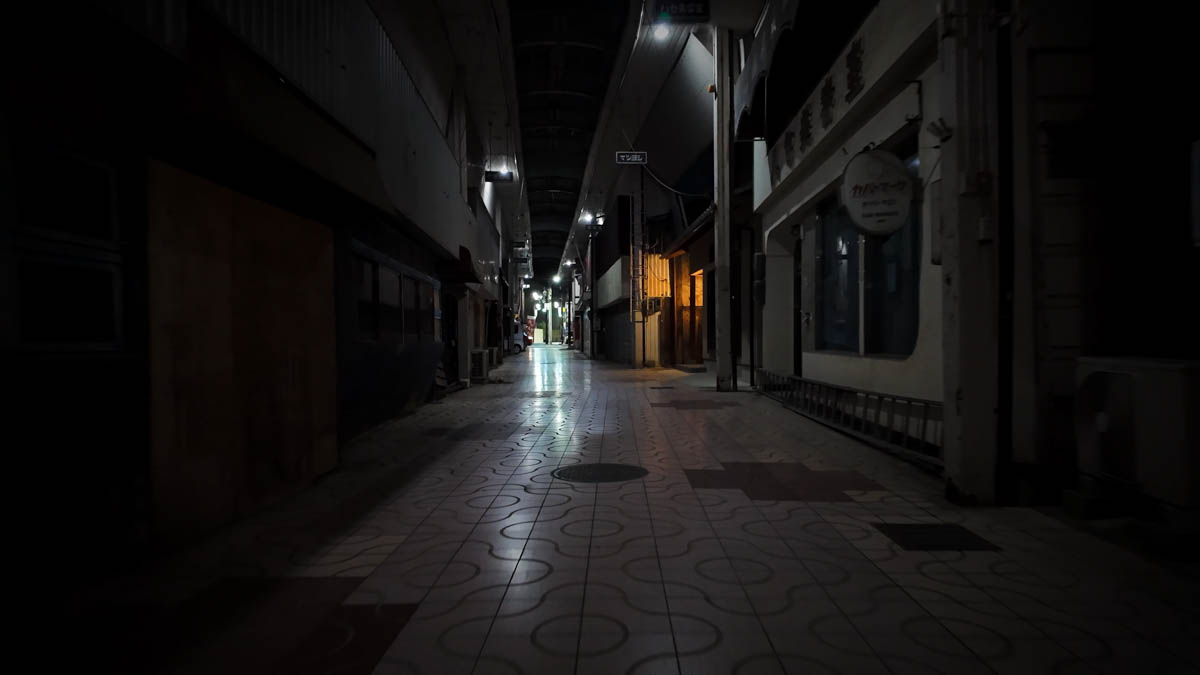 A dark, narrow lane branching off the main arcade