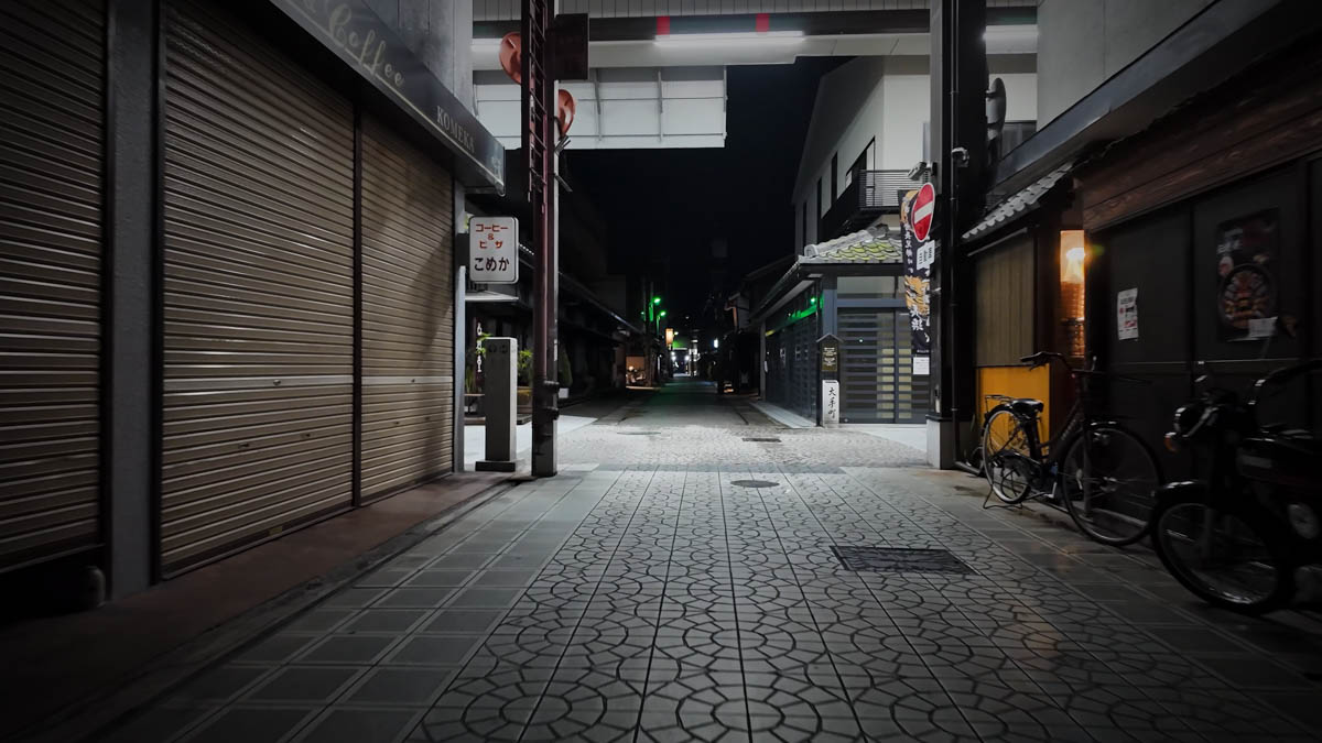A retro handwritten sign reading "Coffee & Pizza" visible on a closed shopfront