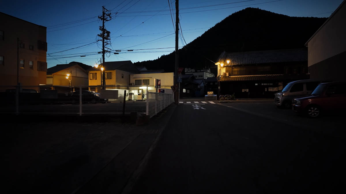Sunset sky and mountain silhouette The sky over Hida-Kanayama turning from crimson to violet, the silhouette of an unnamed mountain rising behind the town