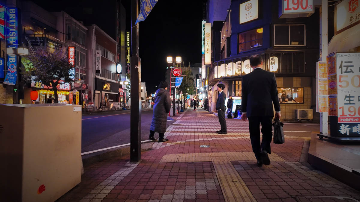 Touts standing outside bars and clubs on the entertainment district street