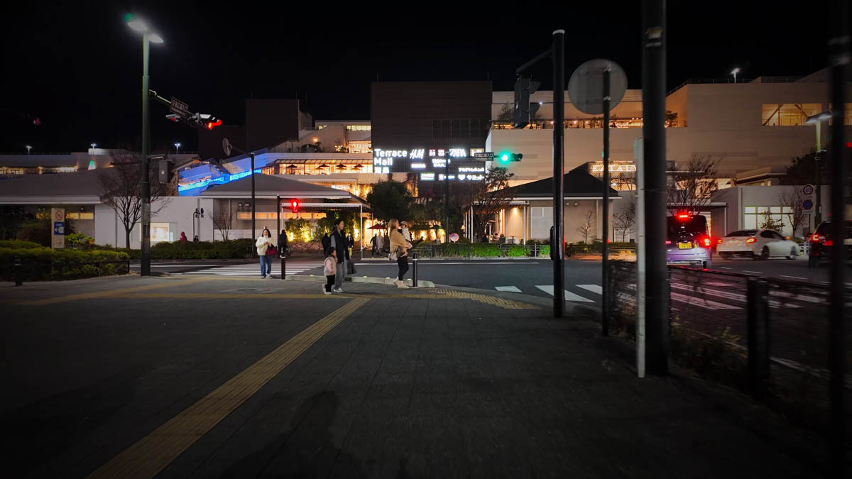 The station plaza busy with families and young children. Terrace Mall Shonan visible in the background