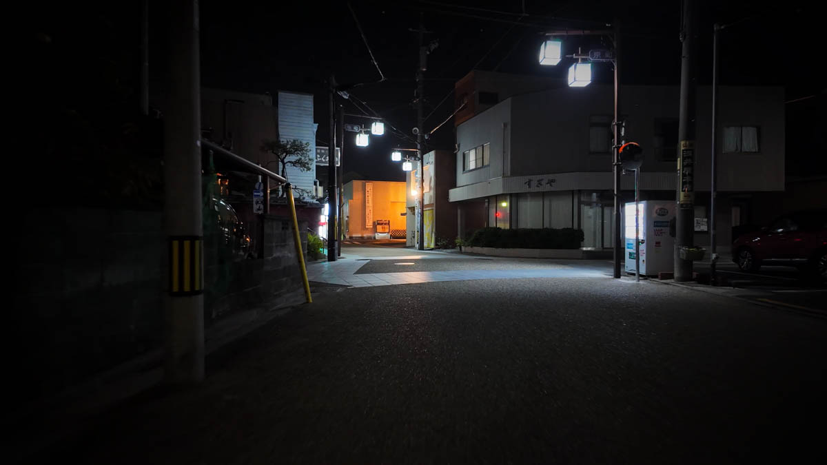A dark street at night, branching toward the old Tokaido road