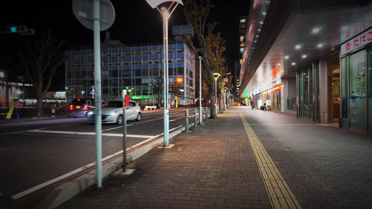 Kuwana Station plaza. An unlit abandoned building is visible on the left