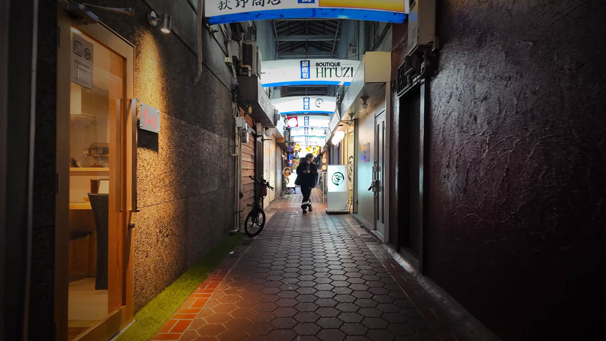 A building housing a cluster of small restaurants, with a narrow alleyway feel