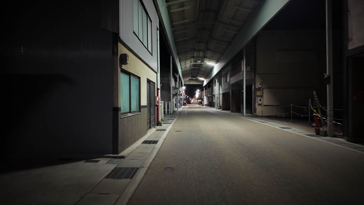 An empty covered arcade in Kamimachi Shopping Street, with lights continuing into the distance