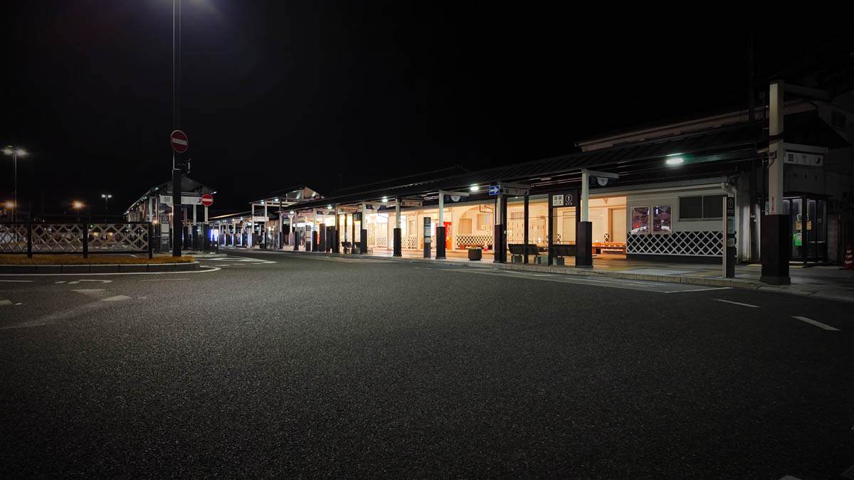 Tsuyama Station at night, with a castle-town-inspired white-wall exterior and the station rotary in front