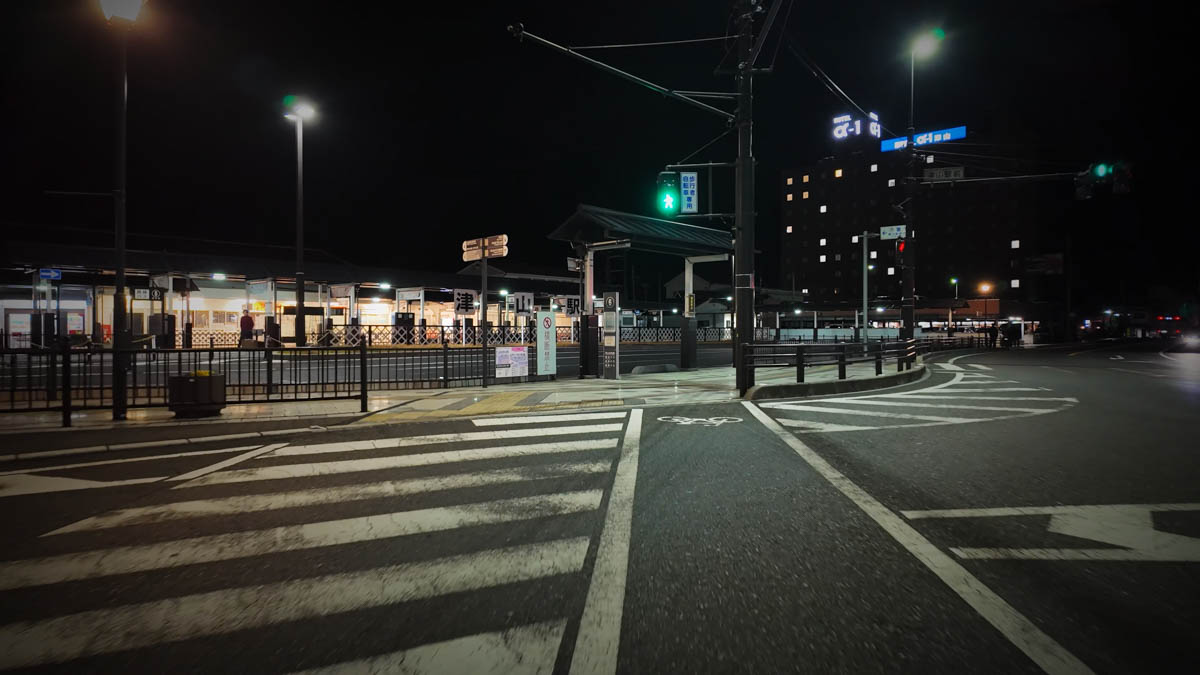 The intersection in front of Tsuyama Station at night, with the station building and hotel lights visible