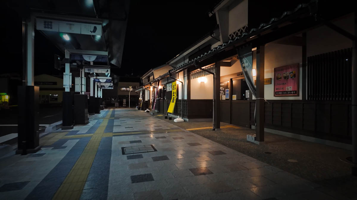 The tourist information center and Nigiwai Exchange Hall beside Tsuyama Station, lit at night with a Japanese-style exterior
