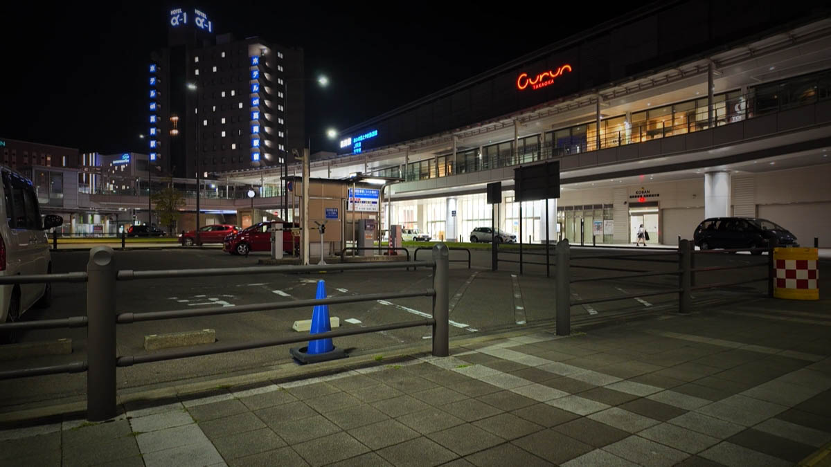 Curun TAKAOKA at night Takaoka Station at night — red Curun TAKAOKA neon and Hotel Alpha-1 Takaoka Ekimae