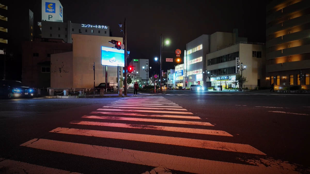 Zebra crossing on Kita-odori with a blue LED screen and Comfort Hotel sign