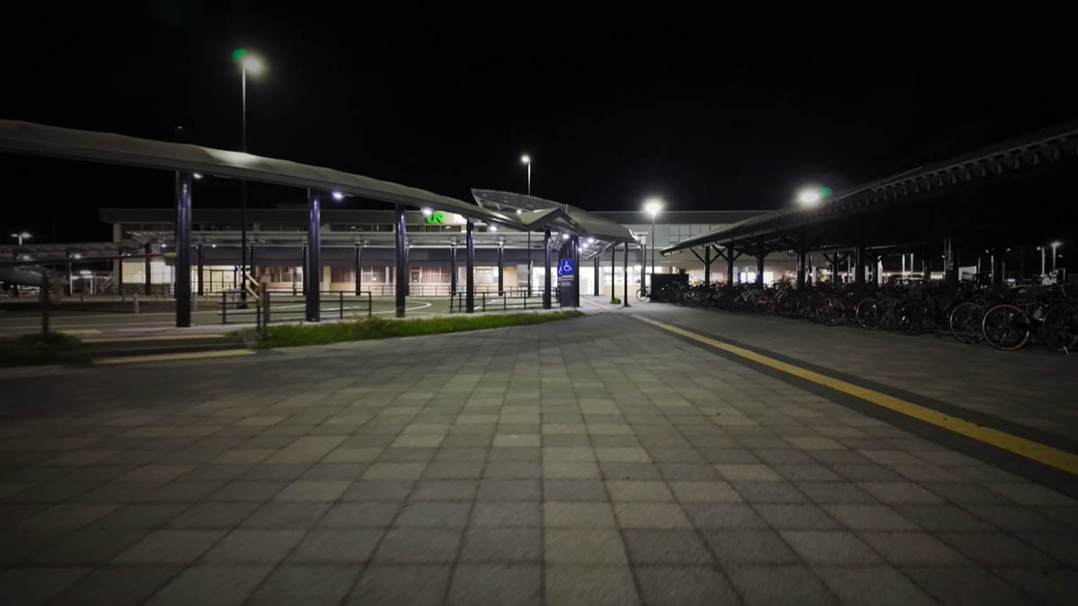 Station plaza with bike parking, covered walk, JR lights