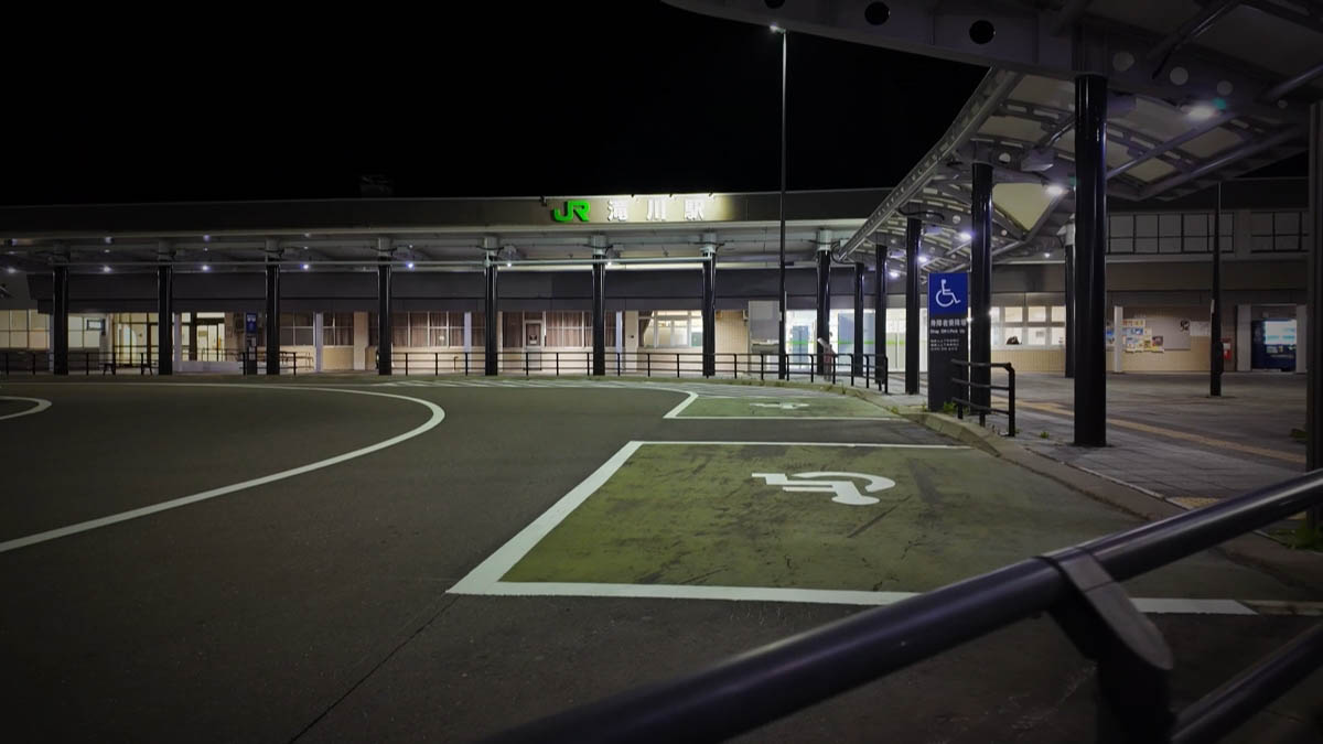 JR Takikawa Station at night, wheelchair markings on the empty rotary