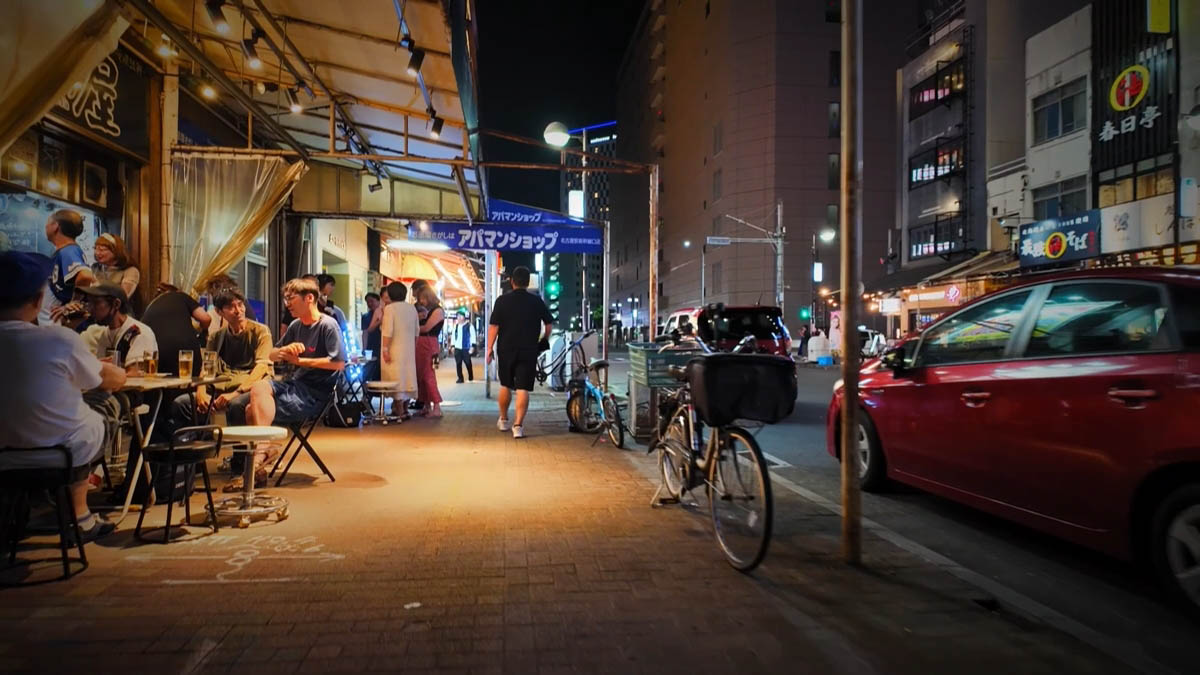 Tables on the sidewalk Outdoor tables under an Apamanshop awning