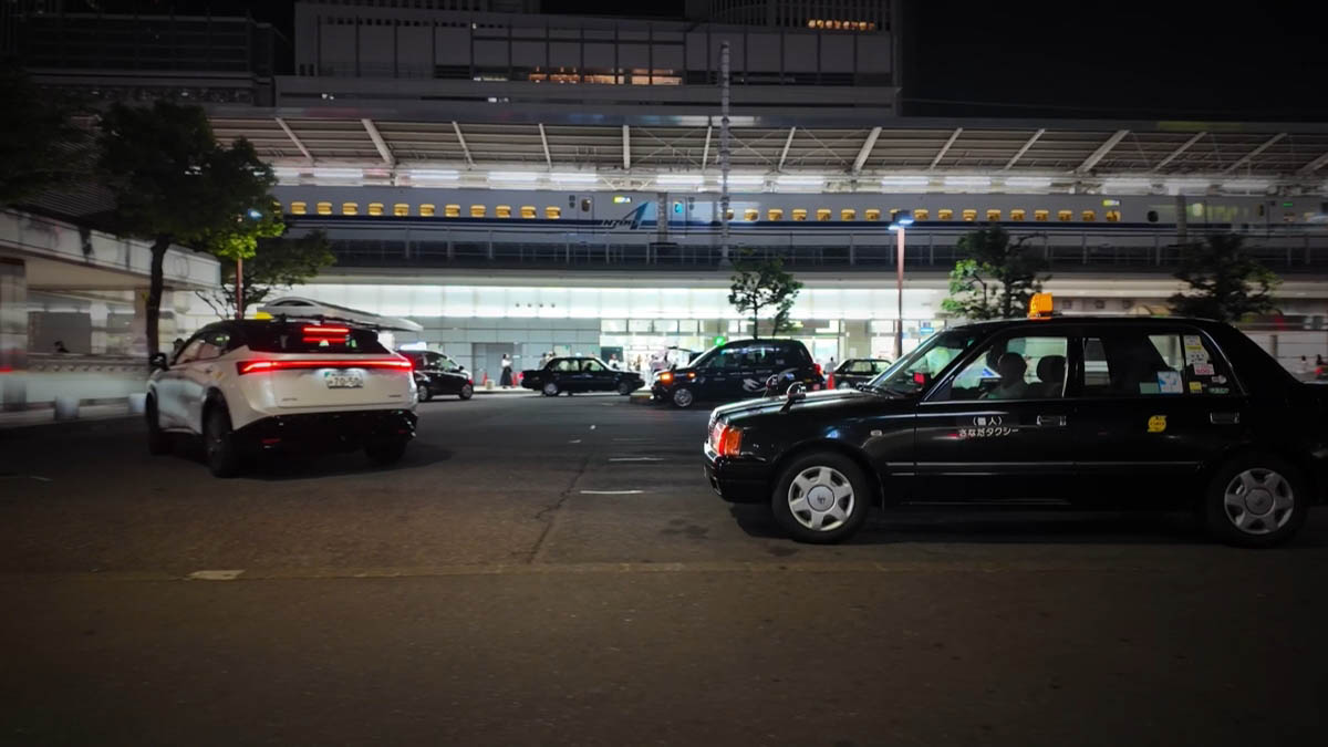 Taxis under the shinkansen Shinkansen viaduct above a taxi rank and a white car